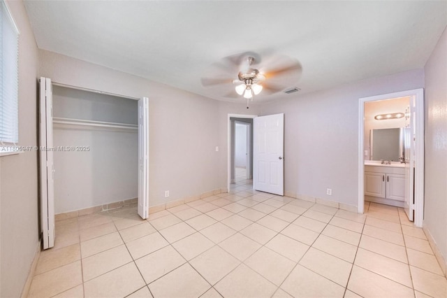 6871 SW 18th St, North Lauderdale, FL 33068 - unfurnished bedroom with light tile patterned flooring, a closet, ceiling fan, and connected bathroom