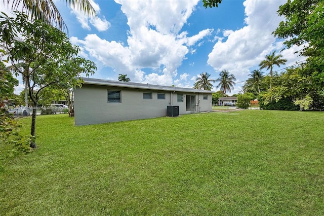 6871 SW 18th St, North Lauderdale, FL 33068 - back of house featuring central AC unit and a yard
