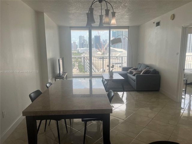 1750 N Bayshore Dr Unit 1410, Miami, FL 33132 - dining space with a wall of windows, a textured ceiling, baseboards, and tile patterned floors