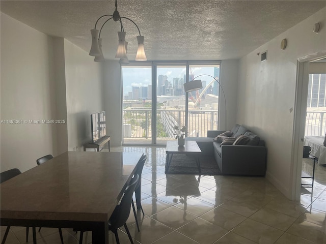 1750 N Bayshore Dr Unit 1410, Miami, FL 33132 - tiled dining room featuring a wall of windows, a textured ceiling, and a chandelier