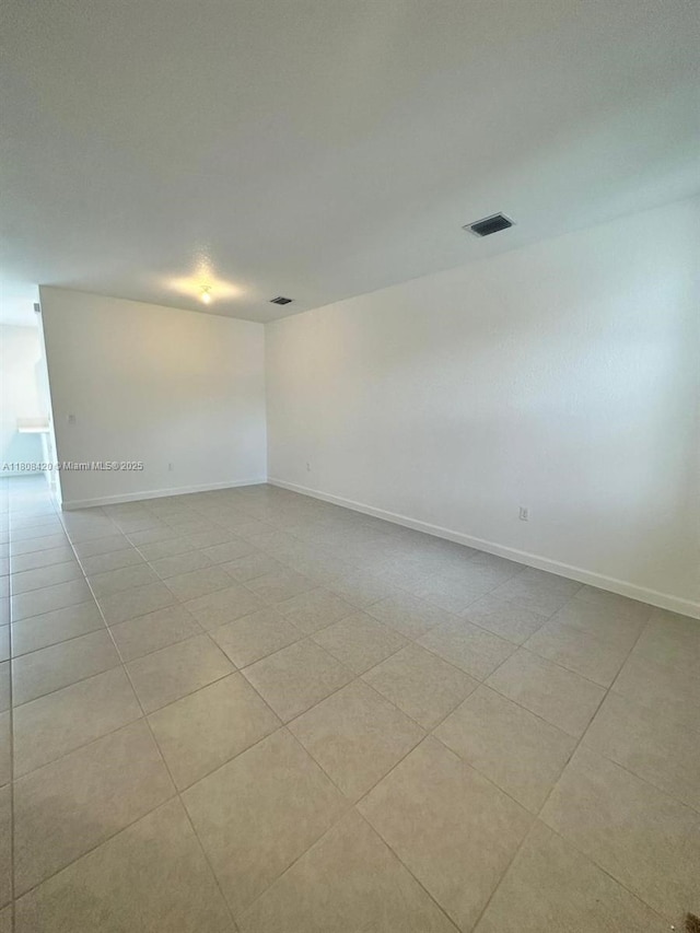 11965 NW 47th Mnr, Coral Springs, FL 33076 - empty room featuring baseboards and tile patterned flooring