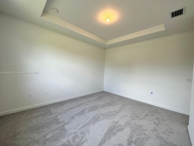 11965 NW 47th Mnr, Coral Springs, FL 33076 - carpeted spare room with a tray ceiling, baseboards, and a smoke detector