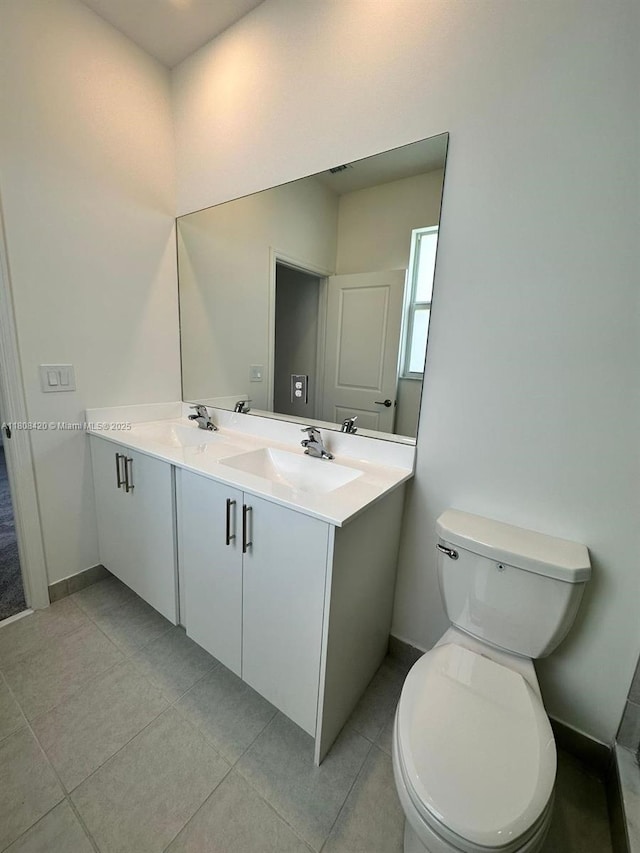 11965 NW 47th Mnr, Coral Springs, FL 33076 - bathroom with double vanity, toilet, baseboards, and tile patterned floors