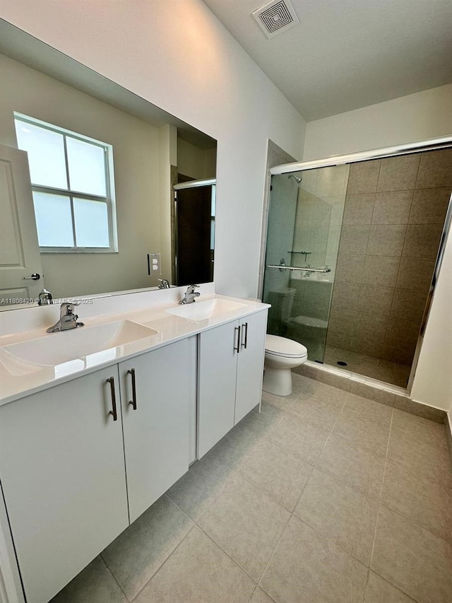 11965 NW 47th Mnr, Coral Springs, FL 33076 - full bath with double vanity, a stall shower, toilet, and tile patterned flooring