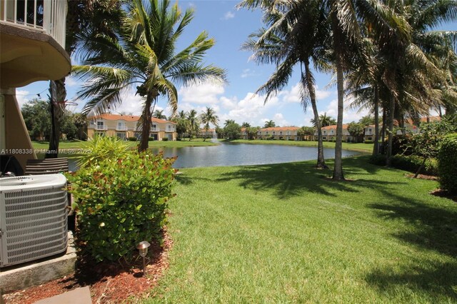 3045 SW 129th Way Unit 152, Miramar, FL 33027 - view of green lawn featuring central AC unit, a water view, and a residential view