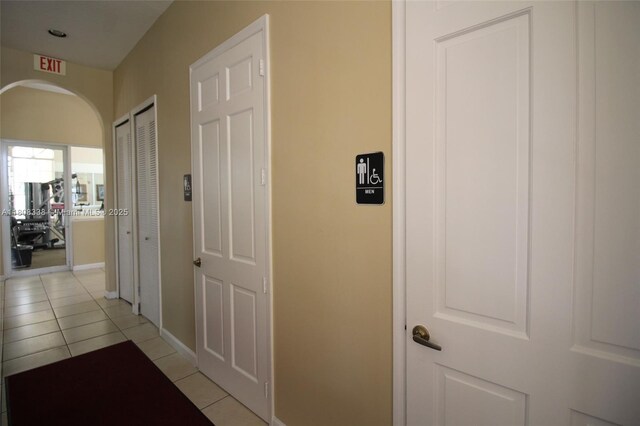 3045 SW 129th Way Unit 152, Miramar, FL 33027 - hallway with light tile patterned floors, arched walkways, and baseboards