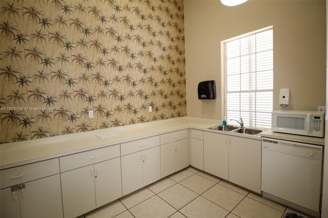3045 SW 129th Way Unit 152, Miramar, FL 33027 - kitchen featuring white appliances, a sink, light countertops, wallpapered walls, and white cabinets