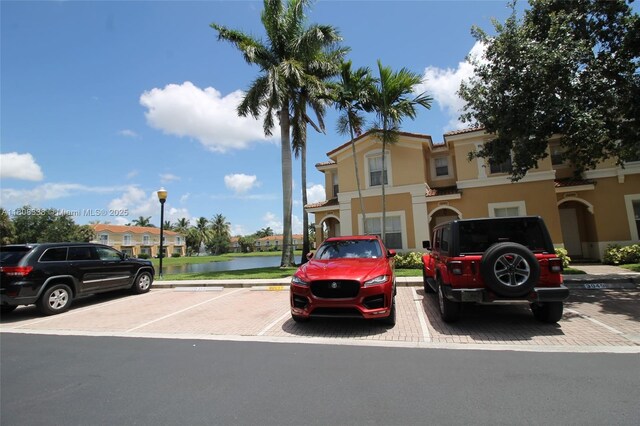 3045 SW 129th Way Unit 152, Miramar, FL 33027 - view of front of house featuring uncovered parking, stucco siding, and a water view