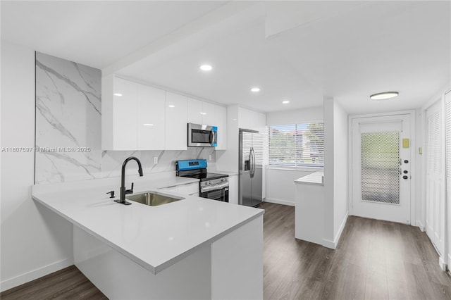 3591 Inverrary Dr Unit 203, Lauderhill, FL 33319 - kitchen featuring appliances with stainless steel finishes, a sink, modern cabinets, light countertops, and white cabinetry