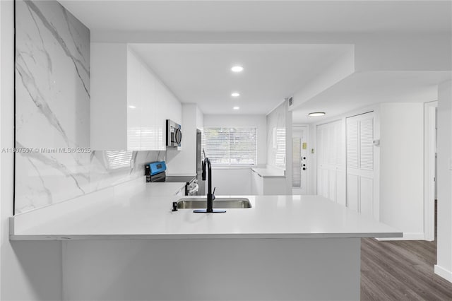 3591 Inverrary Dr Unit 203, Lauderhill, FL 33319 - kitchen featuring stainless steel appliances, a peninsula, light countertops, dark wood finished floors, and recessed lighting