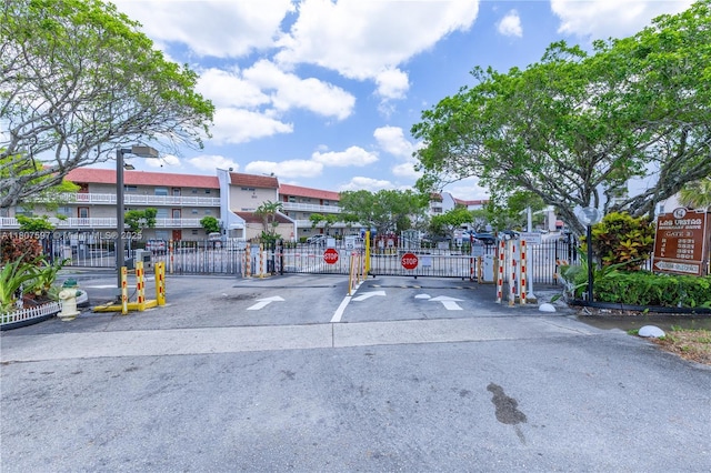 3591 Inverrary Dr Unit 203, Lauderhill, FL 33319 - view of asphalt road with a gate, a gated entry, and traffic signs