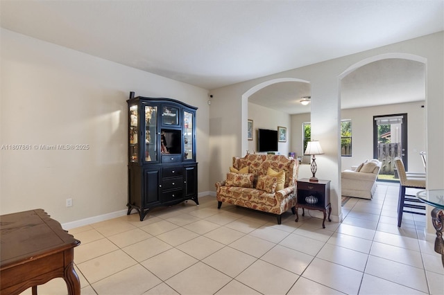 9618 Waterview Way, Parkland, FL 33076 - living area featuring arched walkways, light tile patterned floors, and baseboards