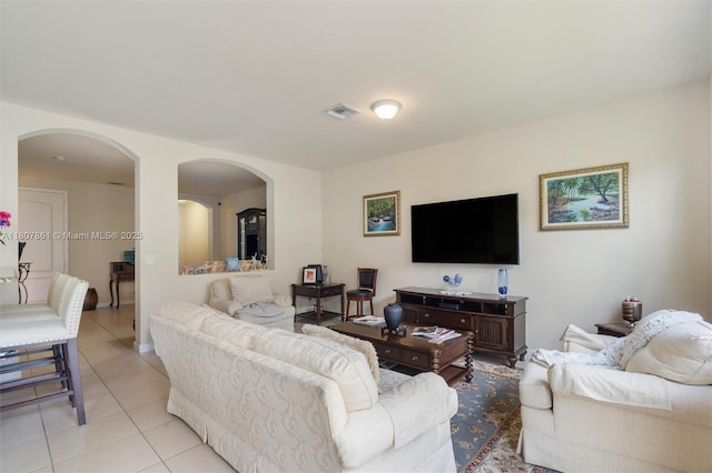 9618 Waterview Way, Parkland, FL 33076 - living room with arched walkways, light tile patterned floors, and baseboards