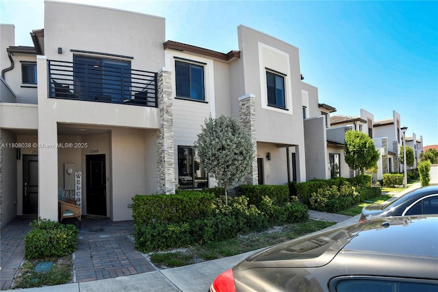 21068 NE 8th Ave, Miami, FL 33179 - view of front facade with stucco siding, a balcony, and a residential view