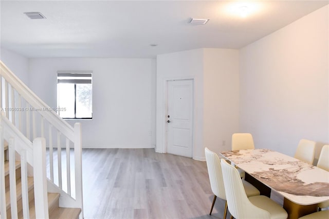 21068 NE 8th Ave, Miami, FL 33179 - dining area featuring light wood finished floors and stairs