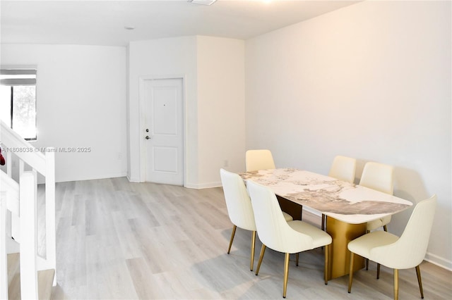 21068 NE 8th Ave, Miami, FL 33179 - dining space with light wood finished floors, baseboards, and stairs