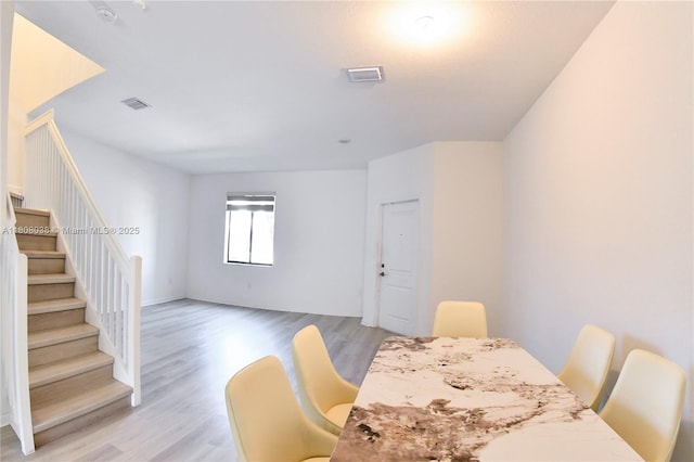 21068 NE 8th Ave, Miami, FL 33179 - dining area with light wood-style floors and stairs