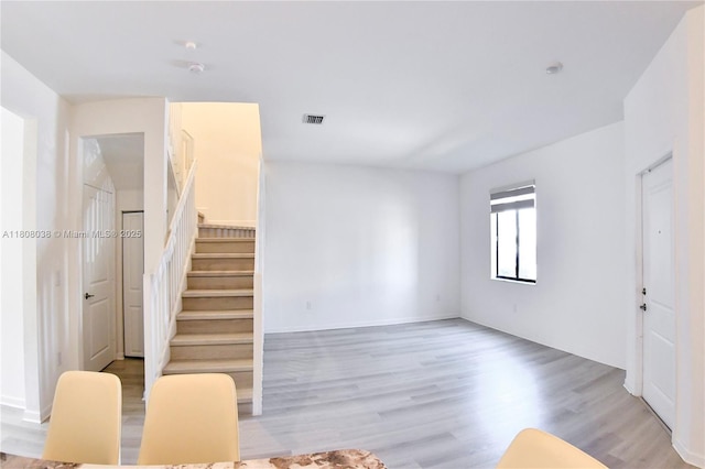21068 NE 8th Ave, Miami, FL 33179 - unfurnished living room featuring wood finished floors and stairway