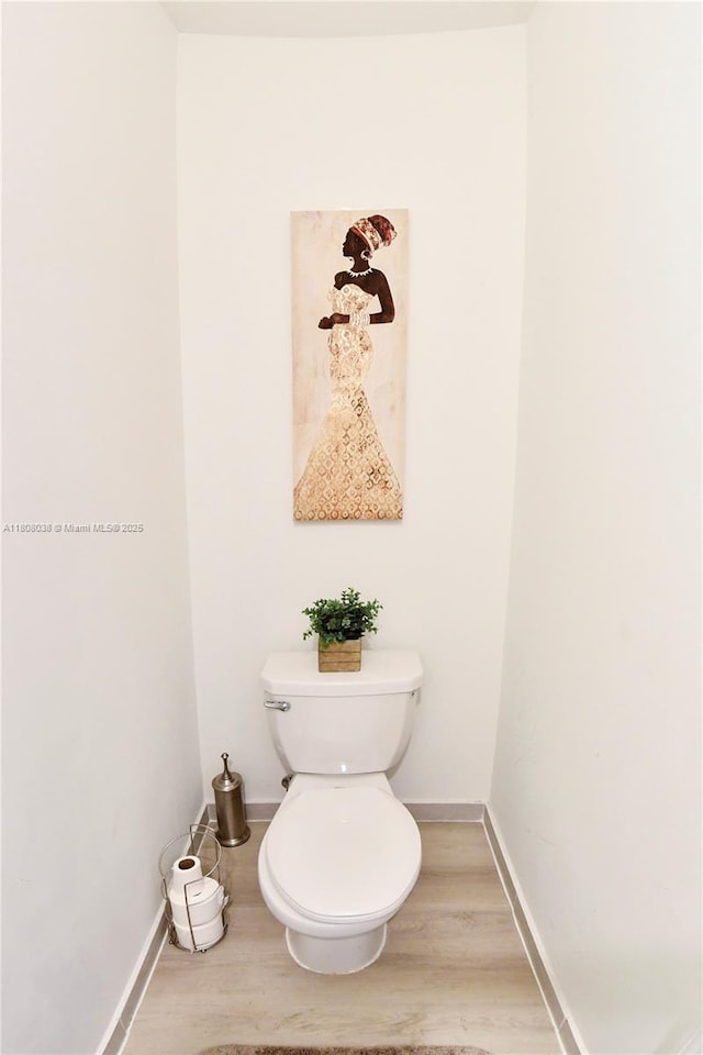 21068 NE 8th Ave, Miami, FL 33179 - bathroom with toilet, wood finished floors, and baseboards