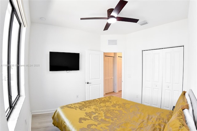 21068 NE 8th Ave, Miami, FL 33179 - bedroom with light wood finished floors, a closet, ceiling fan, and baseboards