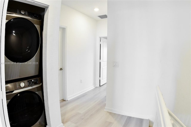 21068 NE 8th Ave, Miami, FL 33179 - laundry room with estacked washer and dryer, light wood-type flooring, baseboards, and recessed lighting