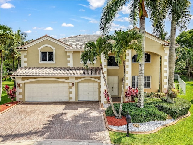 3945 Heron Ridge Ln, Weston, FL 33331 - view of front facade with stucco siding, decorative driveway, and an attached garage