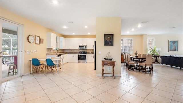 3945 Heron Ridge Ln, Weston, FL 33331 - kitchen with appliances with stainless steel finishes, plenty of natural light, decorative backsplash, light tile patterned floors, and recessed lighting