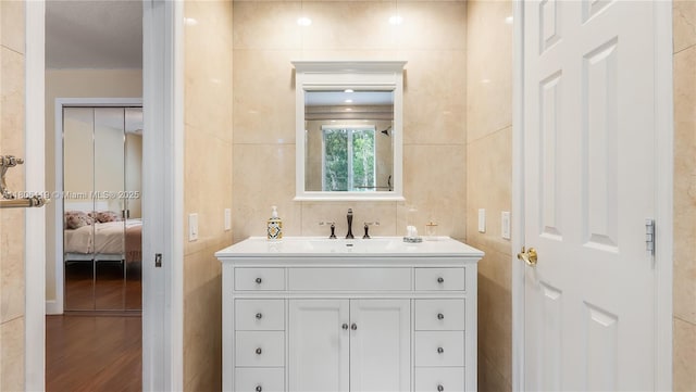 3945 Heron Ridge Ln, Weston, FL 33331 - bathroom featuring vanity, ensuite bath, and wood finished floors