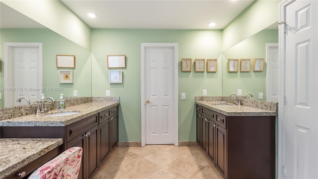 3945 Heron Ridge Ln, Weston, FL 33331 - bathroom featuring two vanities, baseboards, and recessed lighting