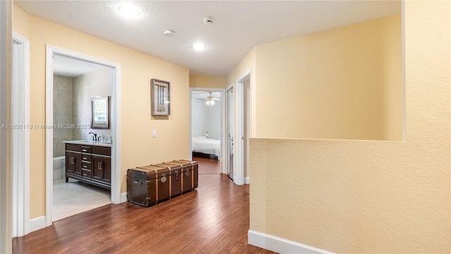 3945 Heron Ridge Ln, Weston, FL 33331 - hallway with wood finished floors, a sink, baseboards, and recessed lighting