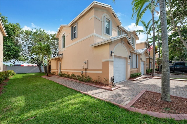 12480 SW 125th Ter, Miami, FL 33186 - view of property exterior featuring stucco siding, decorative driveway, and a garage