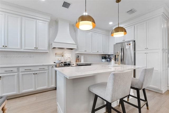 12480 SW 125th Ter, Miami, FL 33186 - kitchen featuring custom range hood, appliances with stainless steel finishes, white cabinetry, and recessed lighting