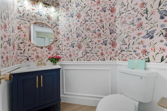 12480 SW 125th Ter, Miami, FL 33186 - half bathroom with wallpapered walls, a wainscoted wall, vanity, toilet, and wood finished floors