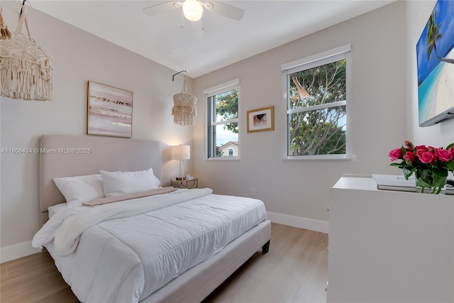 12480 SW 125th Ter, Miami, FL 33186 - bedroom featuring baseboards, wood finished floors, and a ceiling fan