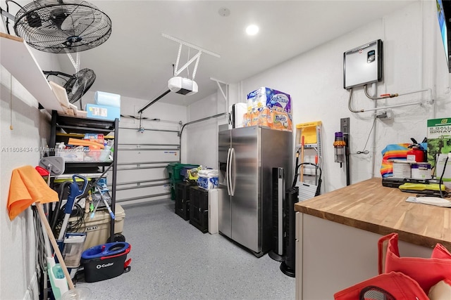 12480 SW 125th Ter, Miami, FL 33186 - garage with stainless steel fridge with ice dispenser, a garage door opener, and recessed lighting