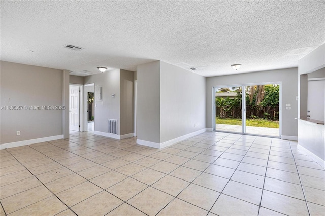 4960 NW 11th Ct, Lauderhill, FL 33313 - unfurnished room with a textured ceiling, baseboards, and light tile patterned floors
