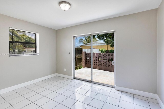 4960 NW 11th Ct, Lauderhill, FL 33313 - empty room with plenty of natural light, baseboards, and light tile patterned floors
