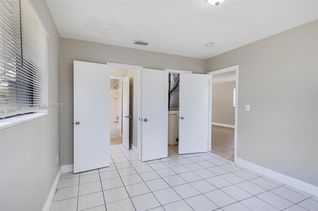 4960 NW 11th Ct, Lauderhill, FL 33313 - unfurnished bedroom with light tile patterned floors and baseboards