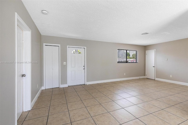 4960 NW 11th Ct, Lauderhill, FL 33313 - empty room with a textured ceiling, light tile patterned floors, baseboards, and a smoke detector
