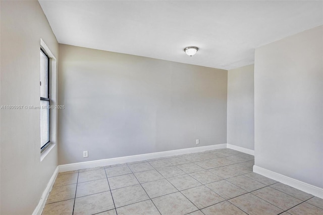 4960 NW 11th Ct, Lauderhill, FL 33313 - empty room with healthy amount of natural light, light tile patterned floors, and baseboards