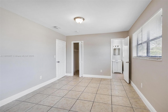 4960 NW 11th Ct, Lauderhill, FL 33313 - unfurnished bedroom with a closet, light tile patterned floors, and baseboards