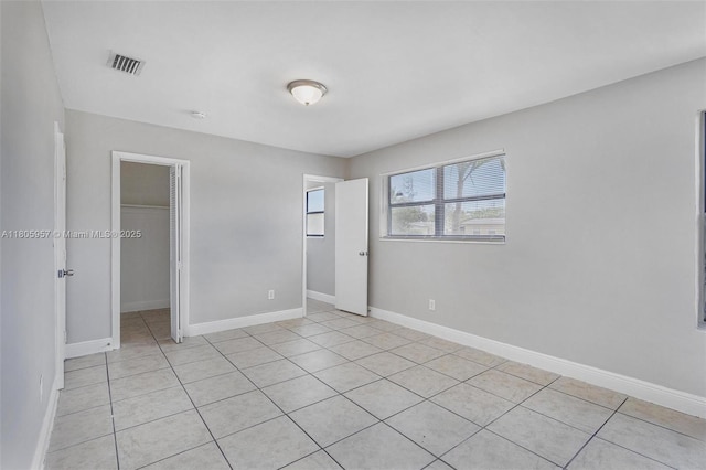 4960 NW 11th Ct, Lauderhill, FL 33313 - unfurnished bedroom featuring a closet, light tile patterned flooring, and baseboards