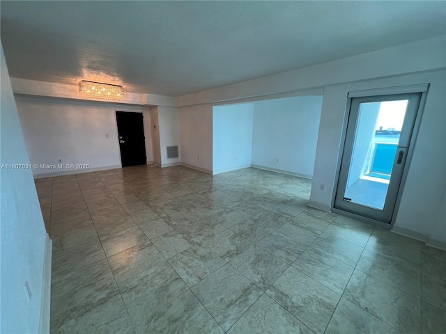 7501 E Treasure Dr Unit 9D, North Bay Village, FL 33141 - empty room with baseboards and tile patterned flooring