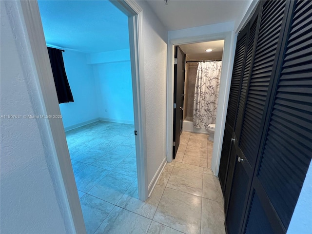 7501 E Treasure Dr Unit 9D, North Bay Village, FL 33141 - hallway featuring light tile patterned flooring and baseboards