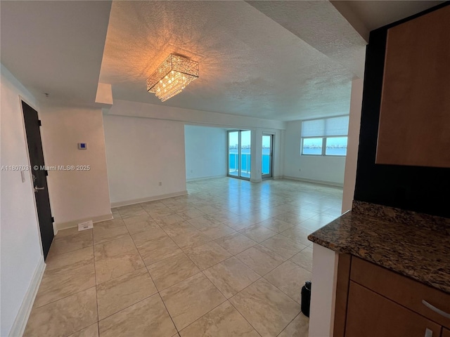 7501 E Treasure Dr Unit 9D, North Bay Village, FL 33141 - empty room with baseboards, a textured ceiling, and light tile patterned floors