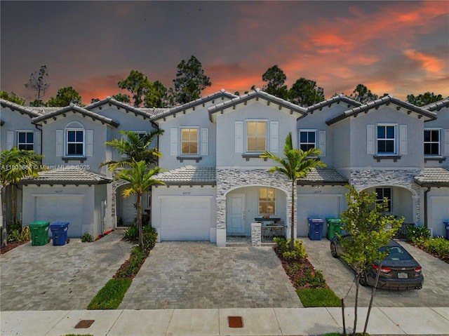 16233 SW 290th Ter, Homestead, FL 33033 - view of front of home with decorative driveway, a tiled roof, an attached garage, and stucco siding