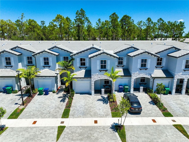 16233 SW 290th Ter, Homestead, FL 33033 - view of property with an attached garage, a tiled roof, stone siding, and a residential view
