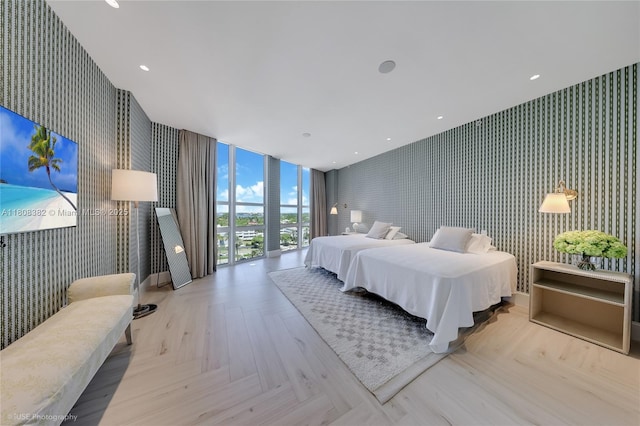 10225 Collins Ave Unit 604, Bal Harbour, FL 33154 - bedroom with wallpapered walls, an accent wall, and floor to ceiling windows