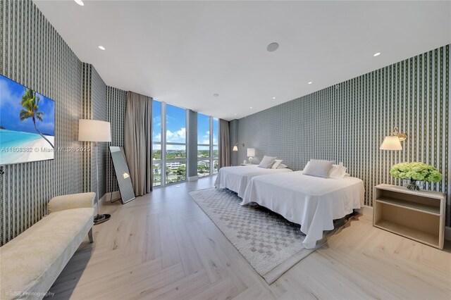 10225 Collins Ave Unit 604Renovated, Bal Harbour, FL 33154 - bedroom with wallpapered walls, an accent wall, and floor to ceiling windows