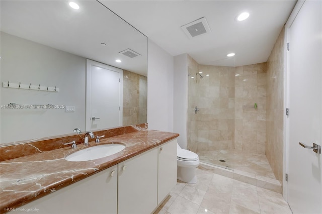 10225 Collins Ave Unit 604, Bal Harbour, FL 33154 - bathroom featuring vanity, toilet, recessed lighting, a tile shower, and tile patterned flooring